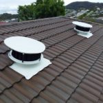 Two Odyssey Roof Vents installed on a brown tile roof